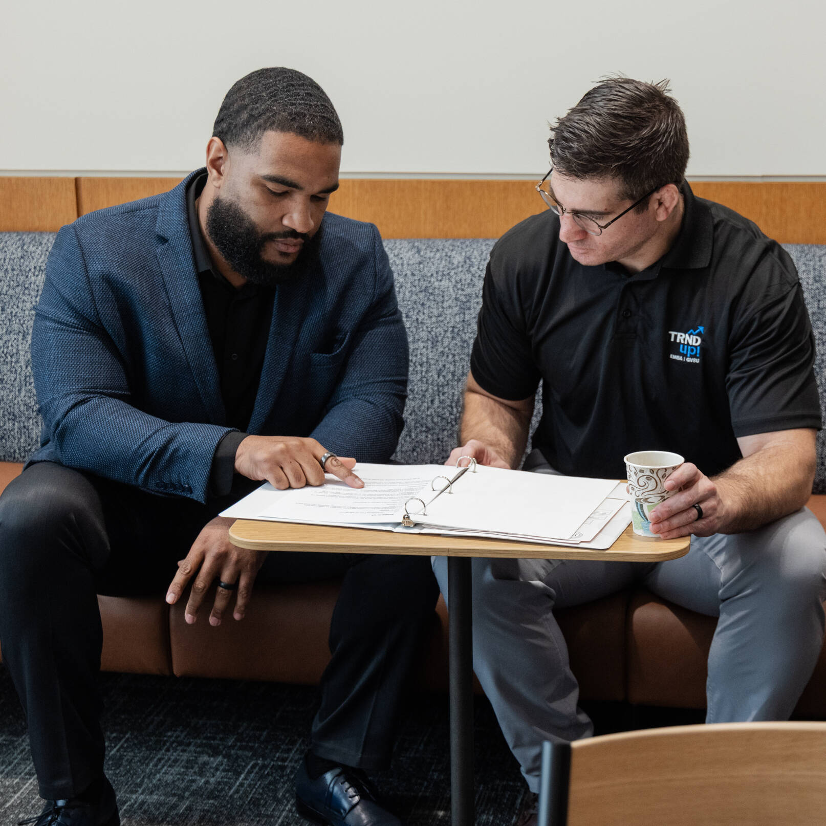 Two EMBA students having a conversation in the sales lab